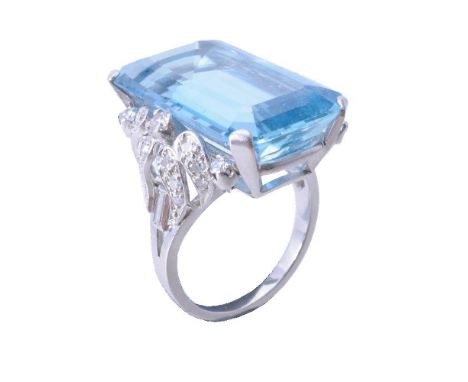 An aquamarine and diamond dress ring, the step cut aquamarine with canted corners estimated to weigh 21.31 carats total, to b