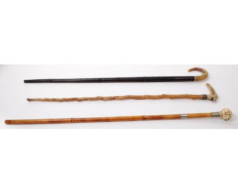 A collection of 20th century walking sticks to include a Japanese style example with resin pommell modelled in the form of se