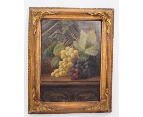 A 19th century Victorian still life oil painting in gilt wood frame. The painting depicts two bunches of grapes atop period o