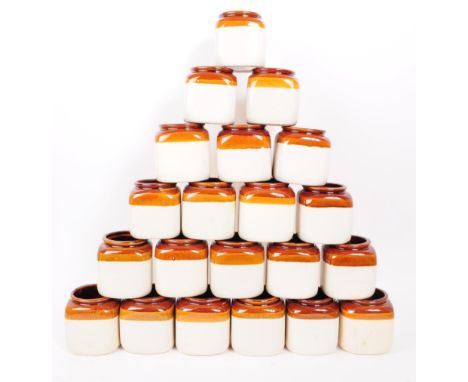A large collection of vintage 20th century kitchen ceramic storage jars with cork lids. Square form with circular opening, br