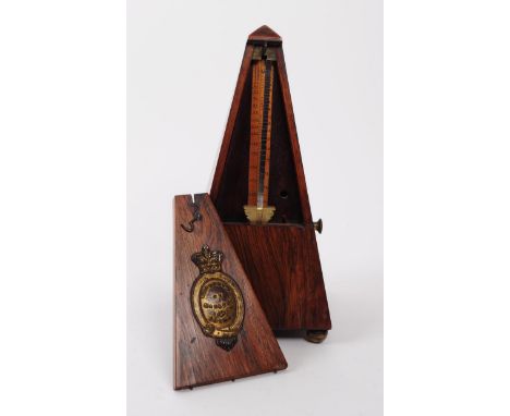 Maelzel - An early 20th century walnut cased Maelzel metronome. The metronome raised on three brass bun feet, with a pyramid 