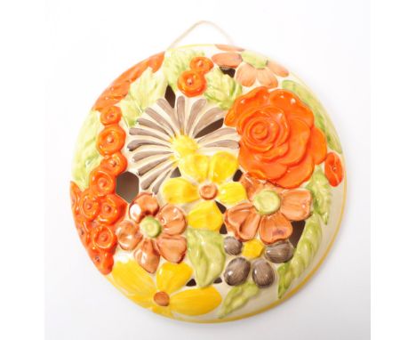 Bizarre by Clarice Cliff - a 20th century ceramic floral wall plaque, with maker's mark printed to the underside. Painted wit