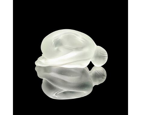 A vintage clear and satin finish figure of a woman resting her upper body on her knees, and hands behind her. Dimensions: 3.2