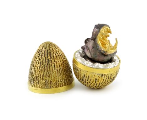 By Stuart Devlin, a silver-gilt surprise egg, London 1973, number 102 of an edition of 300, the egg with textured decoration,