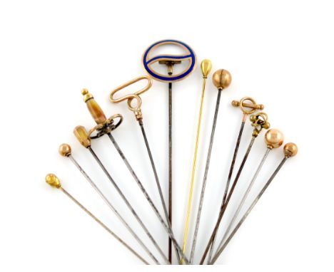 A collection of twelve 9 carat gold hat pins, comprising: a French gold mounted tiger's eye handled sword, one of buckle form
