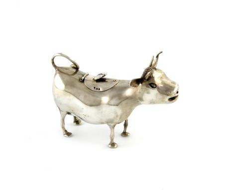A late 19th century Dutch silver cow creamer, with London import marks for 1891, modelled as a standing cow, the hinged cover