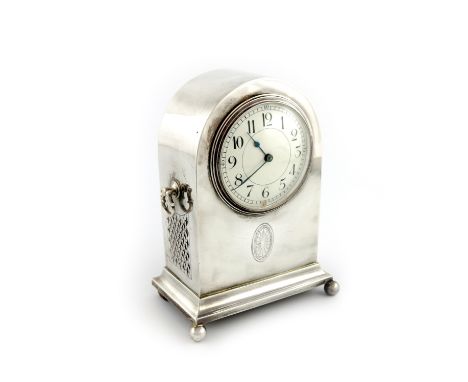 A silver bracket clock, maker's mark worn, Birmingham 1921, of arched upright rectangular form, the front engraved with class