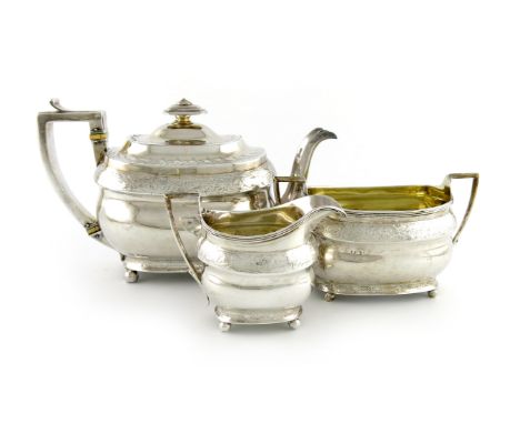 λA three-piece George III silver tea set, Naphthali Hart, London 1805, oblong bellied form, scroll handles, the teapot with i