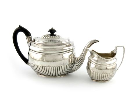 A George III silver teapot and cream jug, by Charles Chesterman, London 1804, oval form, part-fluted decoration, scroll handl