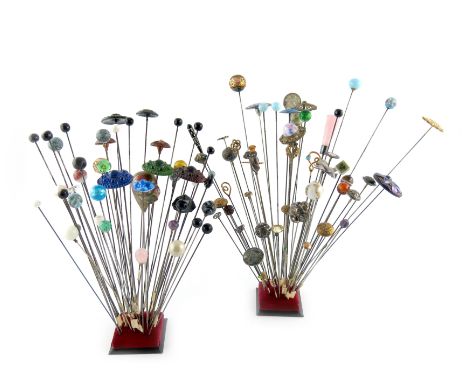 A large collection of hat pins, various materials, including: an electroplated one modelled as a bulldog's head, various silv