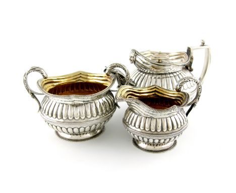 λA matched George III silver tea set, by Solomon Hougham, London 1807 and 1813, circular form, part-fluted decoration, gadroo