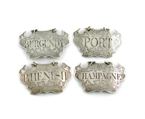 A collection of four George II silver wine labels, by Sandilands Drinkwater, two with his first mark circa 1735, and two circ