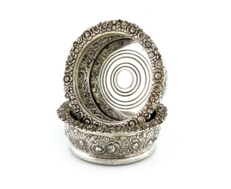 A pair of Victorian silver wine coasters, by Henry Wilkinson and Co, Sheffield 1864, circular form, embossed foliate decorati