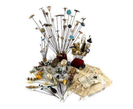 A large collection of hat pins, various materials, including an unmarked silver gold club, various silver and metal ware exam