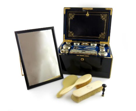λA Victorian silver-gilt travelling dressing table set, by John Harris, London 1853, retailed by F.W. West, No.1 St James's S