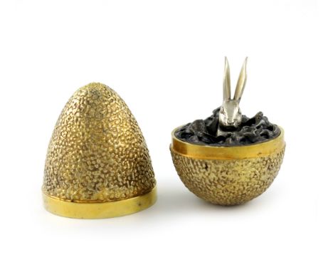 By Stuart Devlin, a silver-gilt surprise egg, London 1969, number 102 of an edition of 300, the egg with textured decoration,
