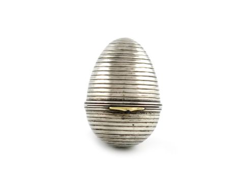 By Fabergé, A Russian silver egg, the gold thumb-piece and body with work master's mark of Henrik Wigstrom, ovoid form, flute