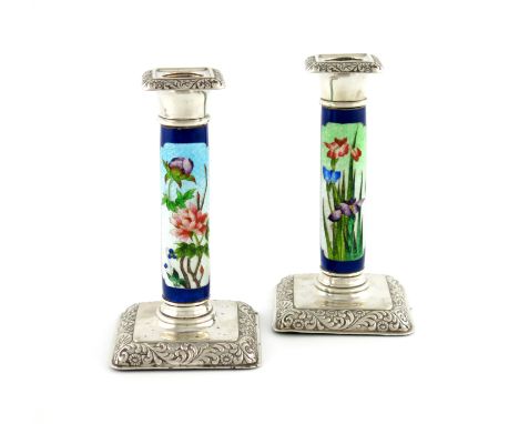 A pair of Edwardian silver and enamel candlesticks, by William Hutton and Sons, Birmingham 1906, the enamelled columns decora