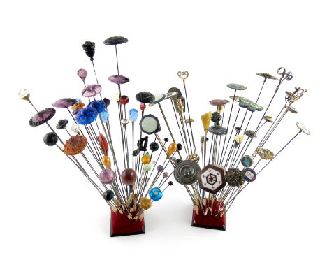 λA large collection of hat pins, various materials, including: one enamelled with an owl on a purple ground, various silver a