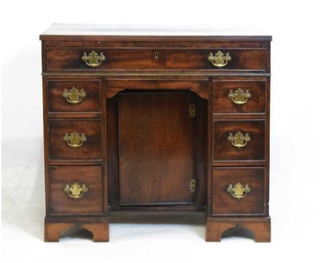 19th Century mahogany kneehole desk, the rectangular top over long frieze drawer, kneehole drawer to apron and recessed cupbo