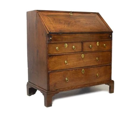 George II oak bureau, circa 1740, the moulded fall front enclosing stepped interior fitted with arrangement of compartments, 
