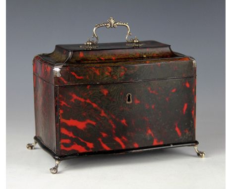 A George III red tortoiseshell serpentine two division tea caddy, with white metal swing handle, corner mounts, with ebonised