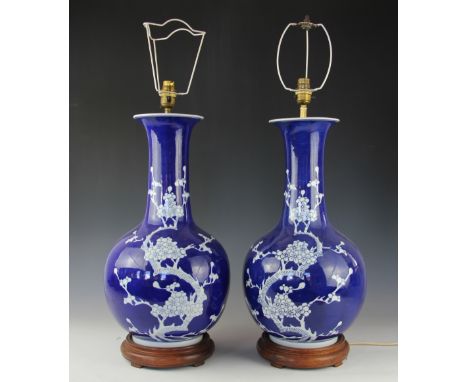 A pair of modern Chinese prunus lamp vases, on turned wood bases, 49cm