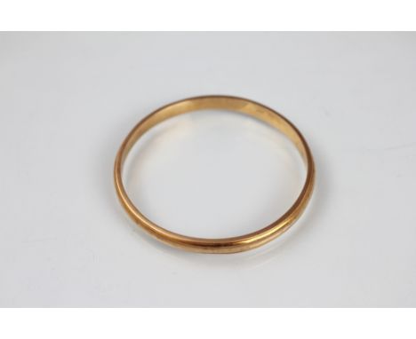 A yellow metal slave bangle, of plain polished form and stamped '15ct', weight 12.6gms 