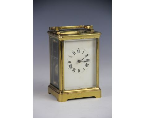 A late 19th century French brass carriage clock, with enamelled Roman numeral dial and movement striking on a gong, 15cm (han