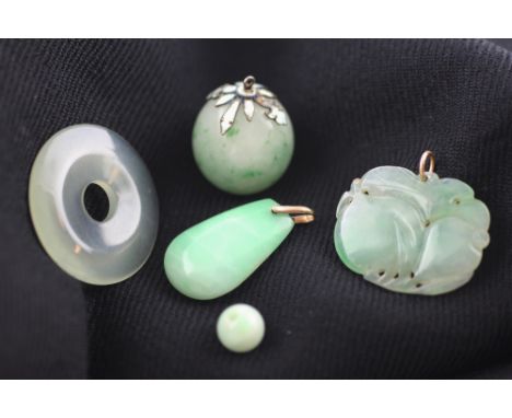 A collection of carved jade and jadeite, to include; a carved jade pendant of fruit, 3.3cm wide, a circular disc 3.5cm diamet