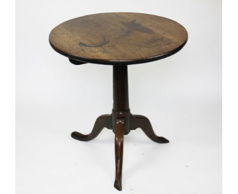 A George III oak circular tilt top occasional table, with turned column on tripod base, 69cm x 67cm