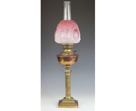 A Victorian brass and copper oil lamp, with moulded and etched graduated pink glass shade, 77cm