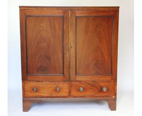 A George III mahogany and cross banded cupboard, with two panelled doors enclosing a shelf, above two drawers, on bracket fee