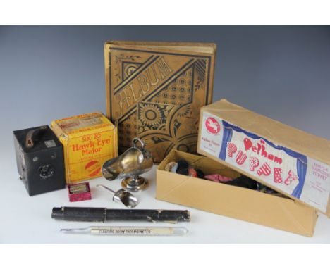 A Pelham Puppet, in associated box, a Kodak Hawk-eye camera in original box, a Lumy bakelite expose meter, a Victorian scrap 