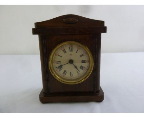 An Edwardian rectangular mahogany mantle clock with enamel dial and Roman numerals