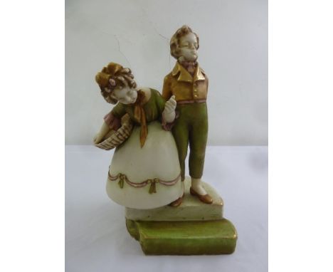 A continental ceramic figurine of a boy and girl on raised onyx plinth