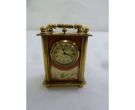A miniature brass carriage clock in the aesthetic style with replacement quartz movement