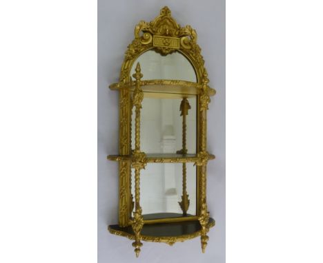 A continental gilded wooden three tier mirrored back wall shelf