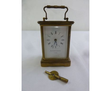 Matthew Norman brass carriage clock of customary form, white enamel dial, Roman numerals to include key