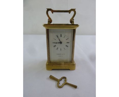 Garrard & Co. brass carriage clock of customary form with enamel dial, Roman numerals to include key
