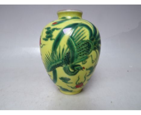 AN ORIENTAL YELLOW GROUND DRAGON EMBELLISHED CERAMIC VASE, of baluster form, character mark to base, H 11 cm