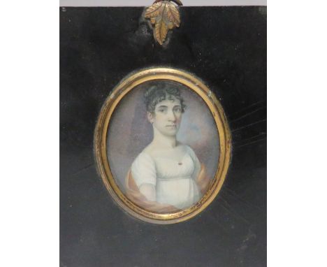 (XIX). An oval portrait miniature on ivory of a woman in white dress and ringlets in her hair, unsigned, frame with acorn fin