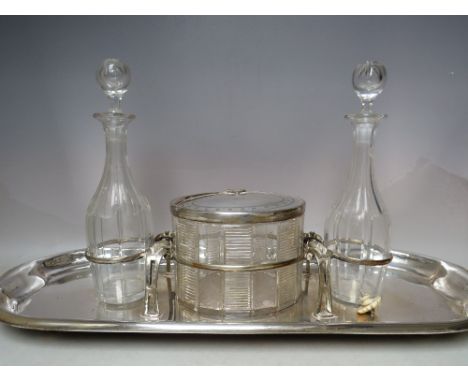 A SILVER PLATED TWO GLASS BOTTLE AND OVAL BISCUIT JAR TANTALUS / SERVING TRAY, tray W 61 cmCondition Report:Unable to open bi