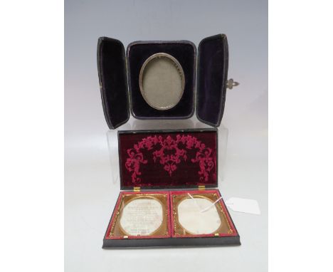A 19TH CENTURY OVAL WHITE METAL PORTRAIT MINIATURE FRAME, set in a leather covered strut back case, 8 x 7 cm, together with a