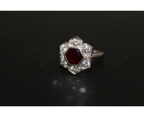 A HALLMARKED 18 CARAT WHITE GOLD RUBY AND DIAMOND RING, set with six brilliant cut diamonds and a further six diamond accents