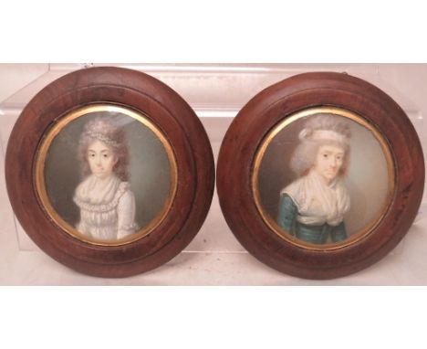 (XVIII-XIX). A pair of circular portrait miniature son ivory of two women with bands in their hair, unsigned, framed and glaz