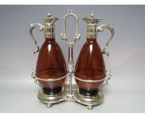 A 19TH CENTURY STYLE SILVER PLATED DECANTER STAND WITH TWO COLOURED GLASS CLARET DECANTERS, overall H 29 cm Condition Report: