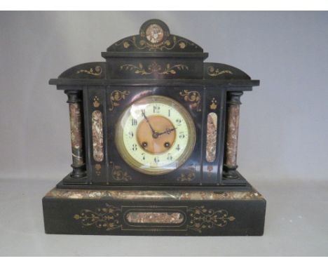 A VICTORIAN BLACK SLATE AND VARIEGATED MARBLE GONG STRIKE MANTLE CLOCK, architectural in form with gold filled engraved decor