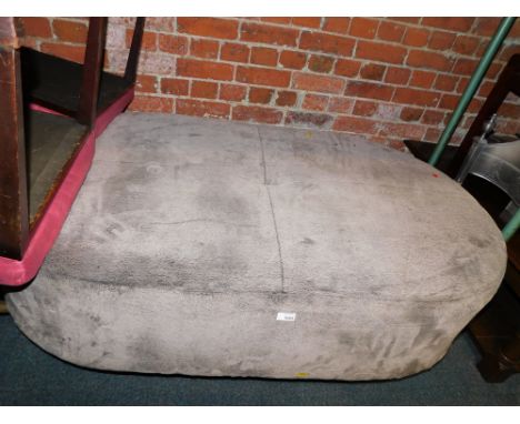A large oval velvet finish centre stool or pouffe.