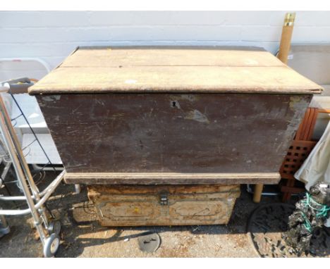 A wooden tool box, 97cm wide, containing a selection of saws and hand tools, together with a metal chest.